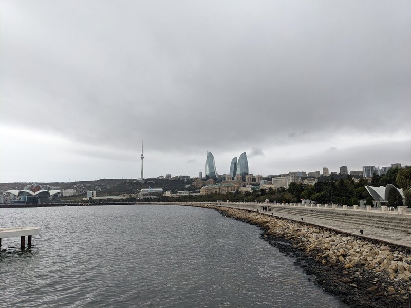 A shoreline with Flame Towers in the distance