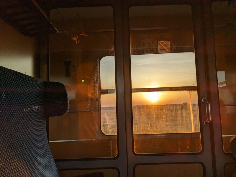 A sunrise seen through a train window