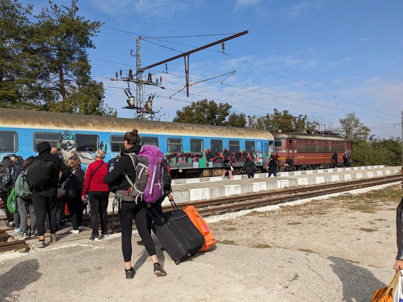 Passengers walking to an old train
