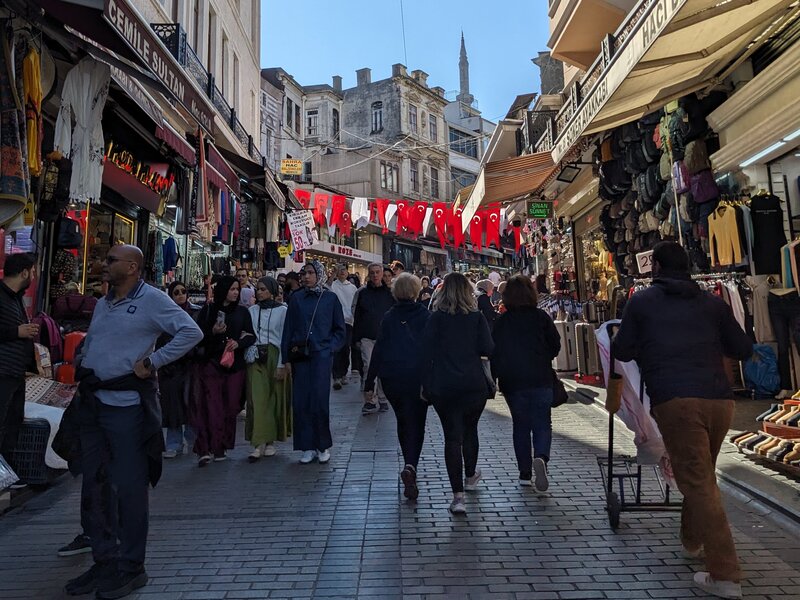 A busy hilly street filled with pedestrians