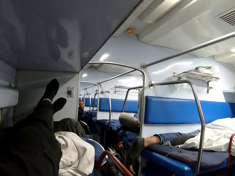 Lying down on the top bunk of a night train with harsh white light
