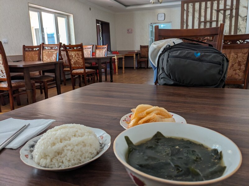 A bowl of rice, a bowl of seaweed soup, and some kimchi