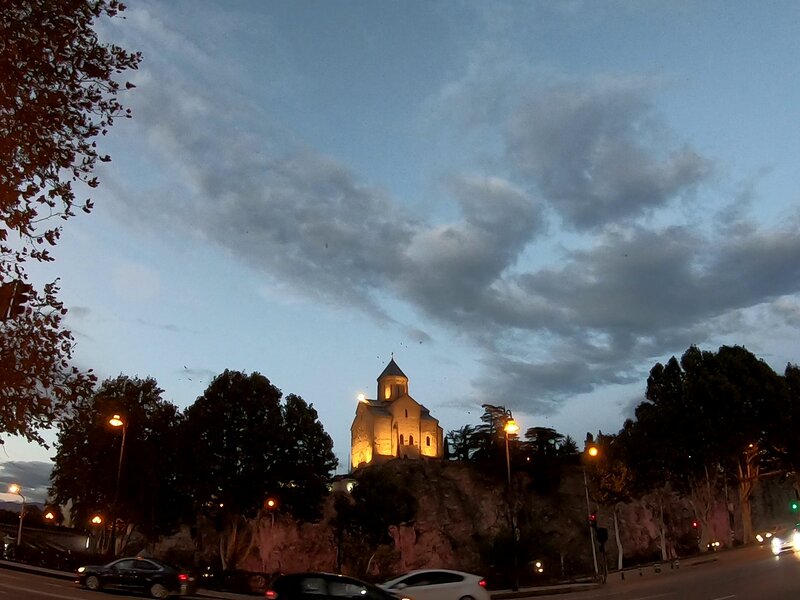 A church overlooking the night streets